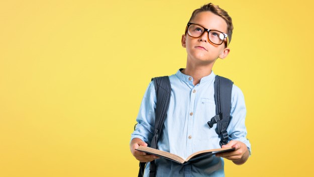 student-kid-with-backpack-glasses-holding-book-yellow-background-back-school_1368-18599